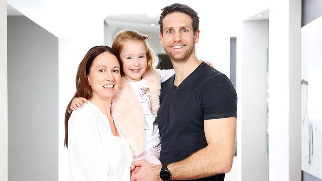 Marika and Troy Lynch with their daughter Mia at home in Cameron Park on the outskirts of Newcastle, which was the top growth suburb in the country for the two decades between 2000 and 2020. Picture: Tim Hunter.