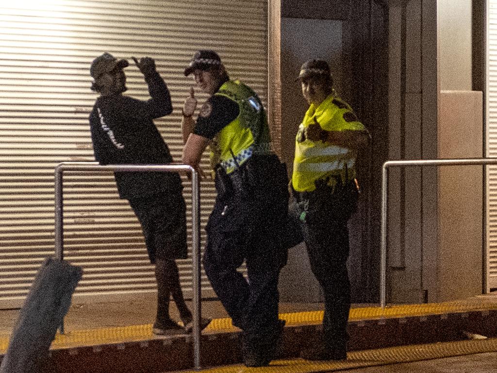 Police officers chat with a man in the Todd Mall in Alice Springs. Picture: Mark Brake