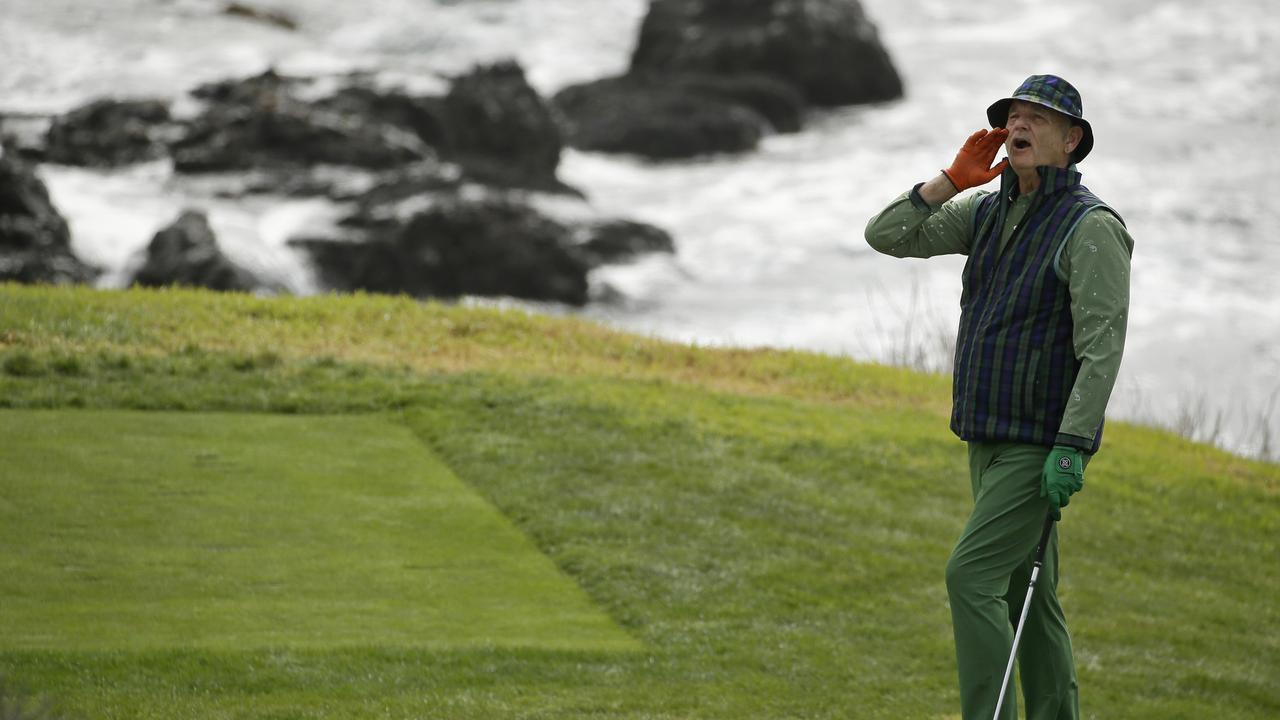 Bill Murray yells "Fore!" to spectators before hitting from the eighth tee at Pebble Beach.
