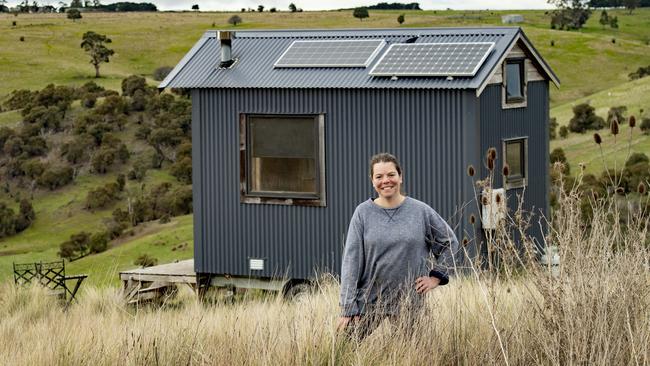 Sarah Ajzner and one of the tiny homes. Picture: Zoe Phillips