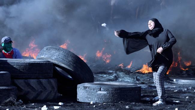 A Palestinian protester confronts Israeli troops at the Hawara checkpoint south of Nablus city in the occupied West Bank. Picture: AFP