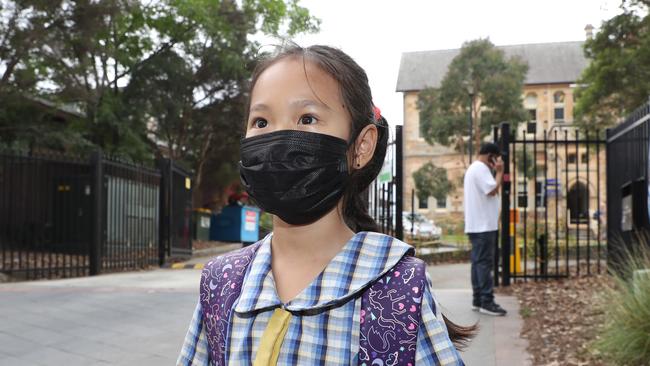 Seven year-old Alex Bang is masked up for the first day of the school year at Ryde Public School today. Picture John Grainger