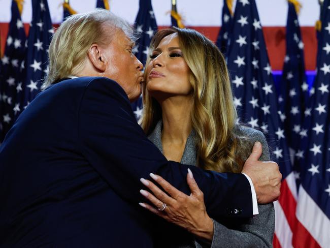 WEST PALM BEACH, FLORIDA - NOVEMBER 06: Republican presidential nominee, former U.S. President Donald Trump kisses former first lady Melania Trump as he arrives to speak during an election night event at the Palm Beach Convention Center on November 06, 2024 in West Palm Beach, Florida. Americans cast their ballots today in the presidential race between Republican nominee former President Donald Trump and Vice President Kamala Harris, as well as multiple state elections that will determine the balance of power in Congress.   Chip Somodevilla/Getty Images/AFP (Photo by CHIP SOMODEVILLA / GETTY IMAGES NORTH AMERICA / Getty Images via AFP)