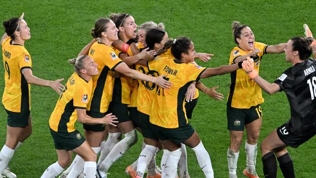 Australia's players celebrate their victory after a penalty shoot-out