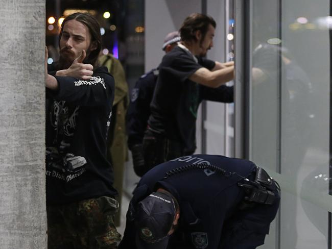 Two men are seen being searched by NSW Police outside an event by Canadian far-right activist Lauren Southern. Picture: AAP Image/Danny Casey