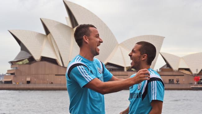 Chelsea football captain John Terry (L) shares a light moment with teammate Eden Hazard (R).