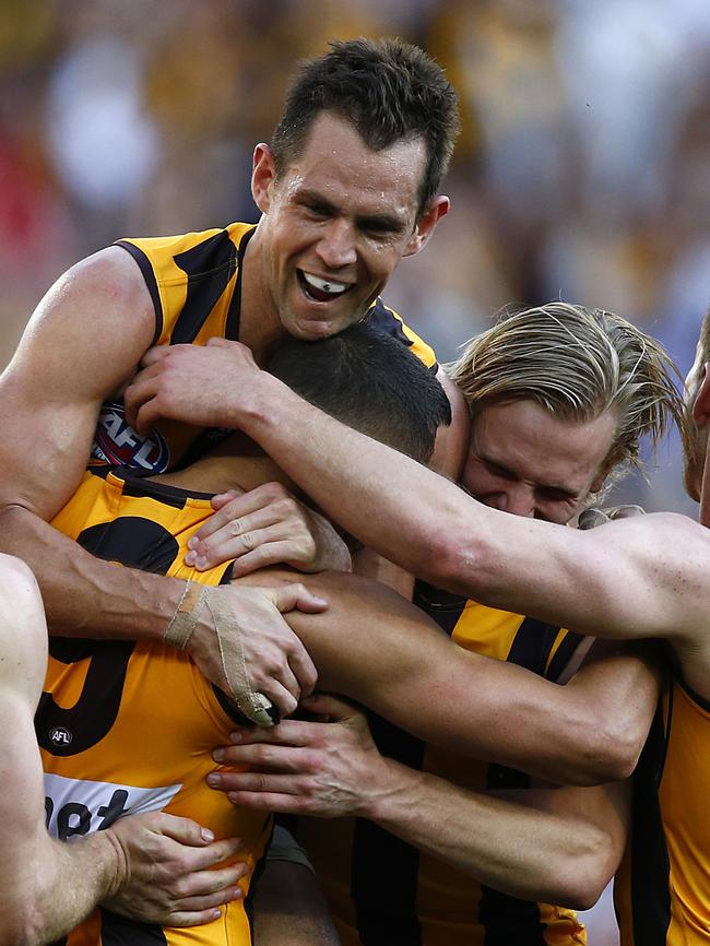 Luke Hodge hugs Shaun Burgoyne after a goal during the 2014 AFL Grand Final win against Sydney. Picture: Wayne Ludbey