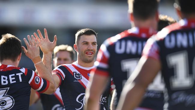 James Tedesco celebrates with Roosters teammates after their win over Canberra. Picture: AAP