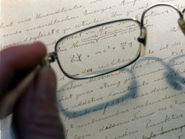 Spectacles reading glasses magnifying privately owned Albert Einstein manuscript circa 1912 detailing theory of relativity, on display at NSW State Library Feb 1996.