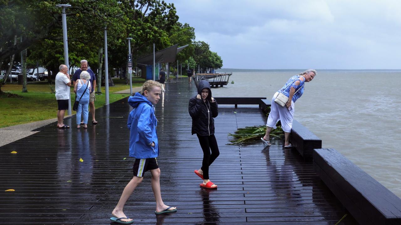 Toby Hickey, 11, and Isla Hickey, 9, from Brinsmead look at the stormy weather on the Cairns Esplanade. Picture: Brendan Radke