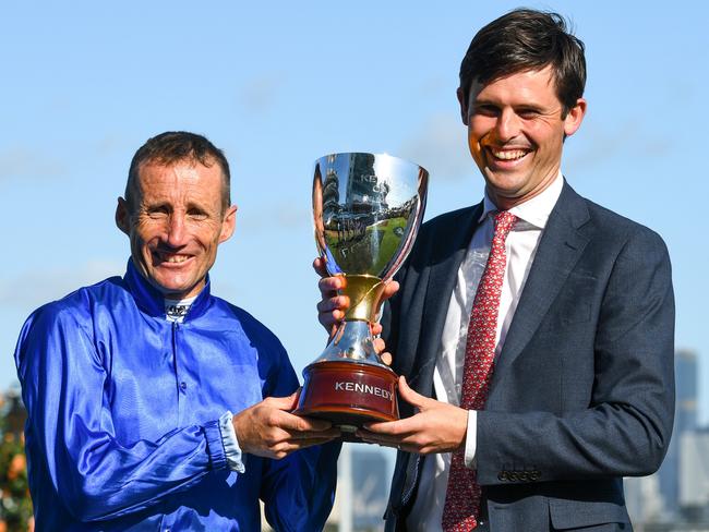 MELBOURNE, AUSTRALIA - NOVEMBER 04: Damien Oliver poses with Trainer James Cummings and trophy after riding Willowy to win Race 8, the Kennedy Oaks, during 2021 Oaks Day at Flemington Racecourse on November 04, 2021 in Melbourne, Australia. (Photo by Vince Caligiuri/Getty Images)