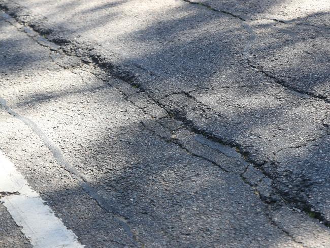Long cracks visible in Belair Rd, which former road safety expert Roger Hancock says is in desperate need of repair.
