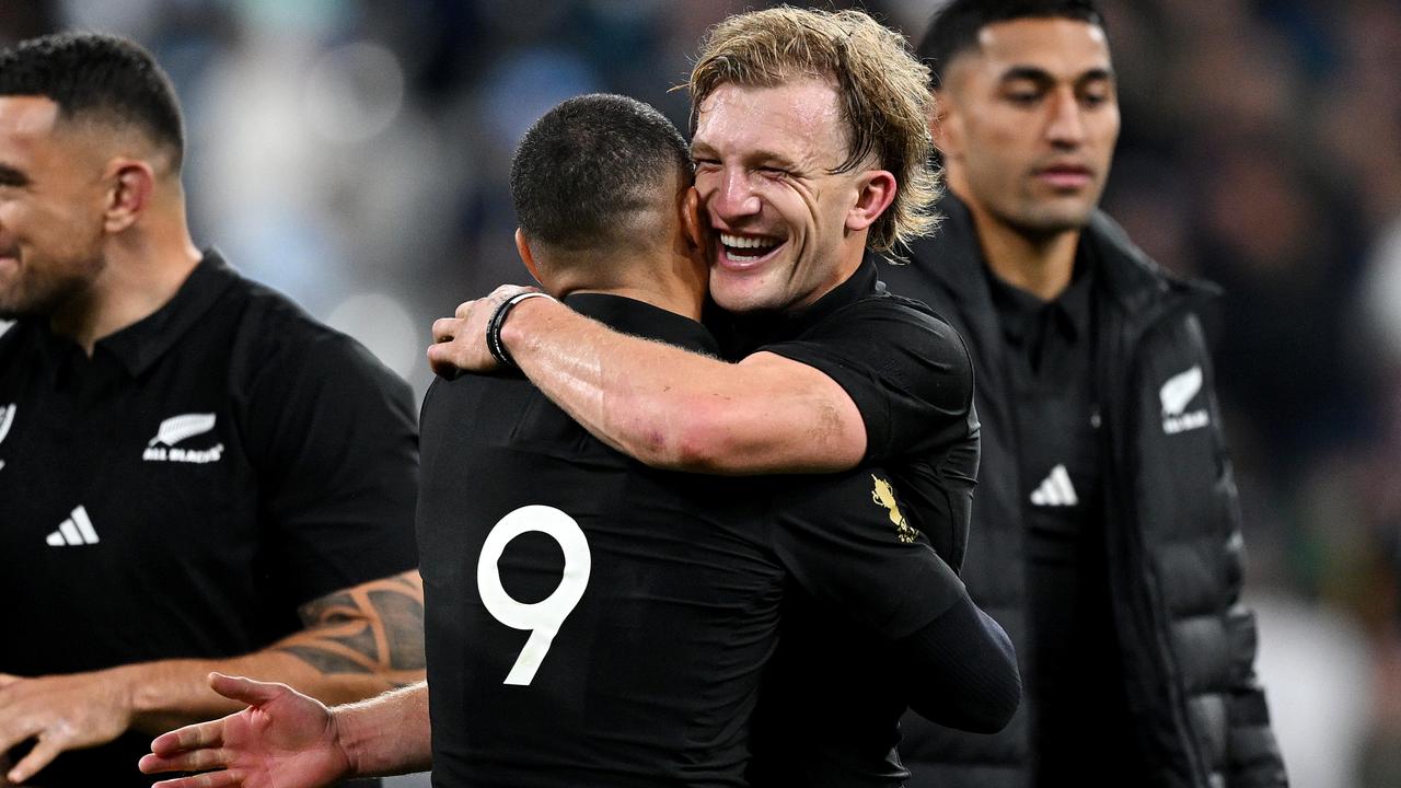 Damian McKenzie of New Zealand embraces teammate Aaron Smith. Photo by Hannah Peters/Getty Images.