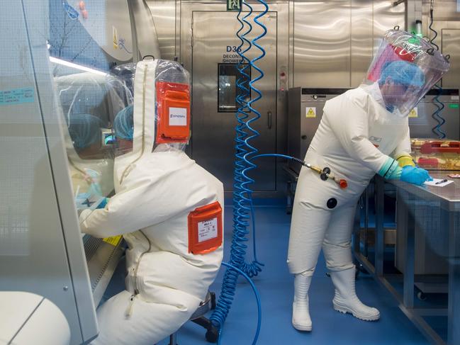 Workers next to a cage with mice inside the P4 laboratory in Wuhan. Picture: Johannes Eisele/AFP