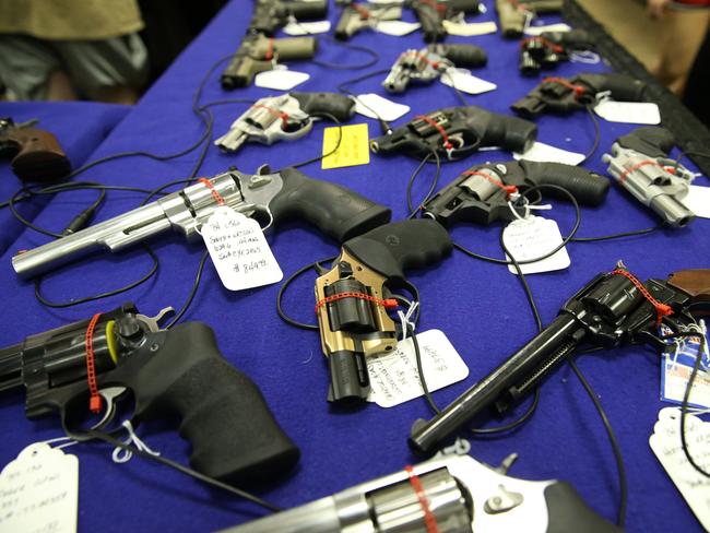 A gun show in Mobile, Alabama. People can walk out the door with an AR-15 assault rifle after passing a quick background check. Picture: Gary Ramage