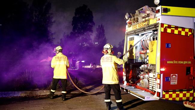 Fire and Rescue officers blacking out after a fire at the brick pit ring walk car park on at Sydney Olympic Park. Picture: Steve Tyson