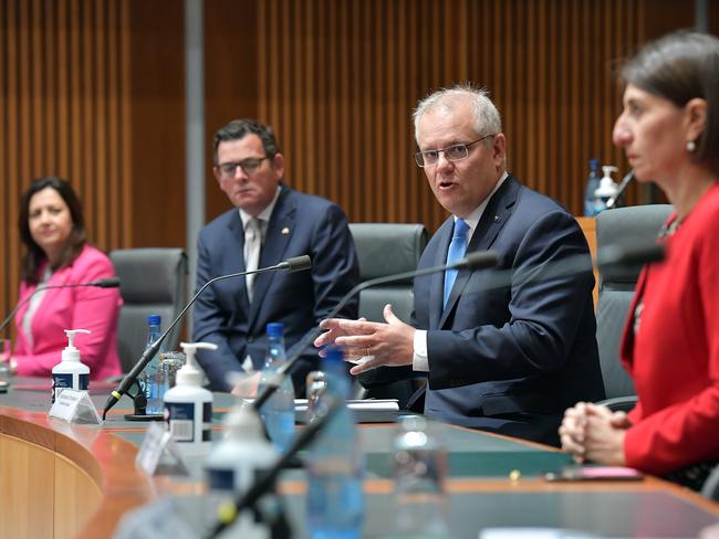 CANBERRA, AUSTRALIA - DECEMBER 11: Australian Prime Minister Scott Morrison (centre) together with State Premiers Annastacia Palaszczuk (left), Daniel Andrews and Gladys Berejiklian address the media in the Main Committee Room at Parliament House, on December 11, 2020 in Canberra, Australia. Australia's leaders are meeting face to face for the first time in nine months, after Prime Minister Scott Morrison convened 32 virtual meetings of the National Cabinet with premiers and chief ministers since March to coordinate responses to COVID-19. (Photo by Sam Mooy/Getty Images)