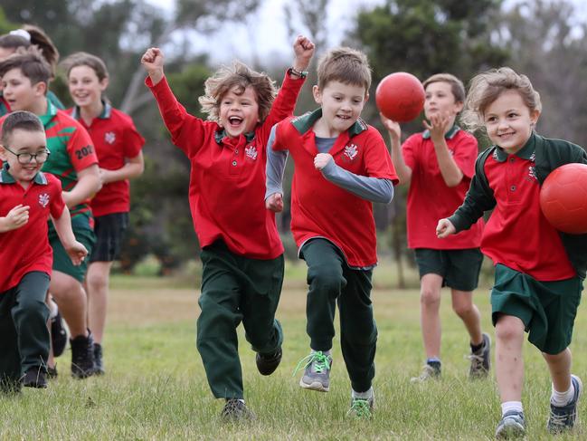 Buxton Public School students including at the front Rory Boys, Lawrence Coyte and Georgia Hale. A grant of $25,000 will be given to the school to replace play equipment which was lost in the bushfires late last year. Picture: Jonathan Ng