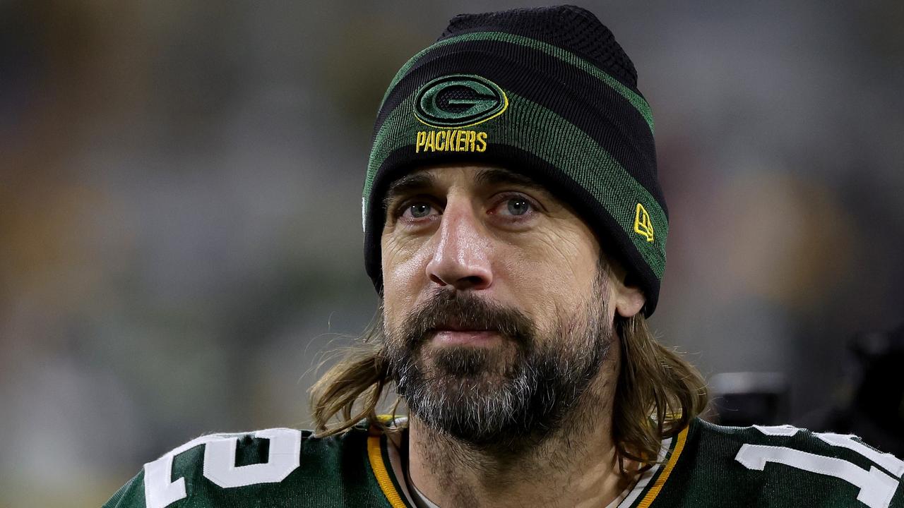 GREEN BAY, WISCONSIN - DECEMBER 25: Aaron Rodgers #12 of the Green Bay Packers walks off the field after beating the Cleveland Browns 24-22 at Lambeau Field on December 25, 2021 in Green Bay, Wisconsin. Stacy Revere/Getty Images/AFP