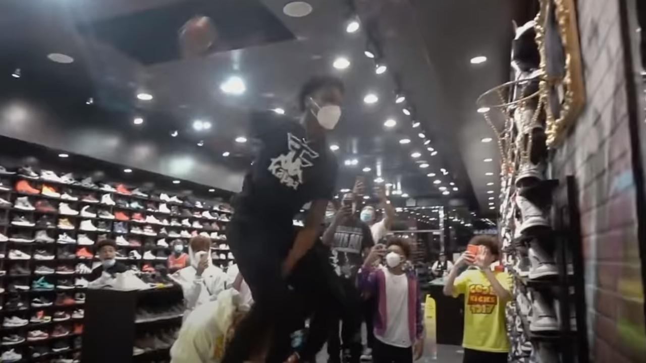 The action begins with Bronny leaping over a boy to dunk a basketball at a streetwear store.