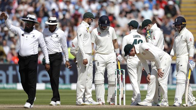 Players gather around a misbehaving stump. Picture: Getty Images