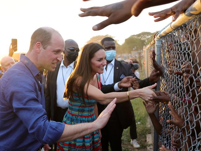 KINGSTON, JAMAICA Ã¢â¬â MARCH 22: Prince William, Duke of Cambridge and Catherine, Duchess of Cambridge shake hands with children during a visit to Trench Town, the birthplace of reggae music, on day four of the Platinum Jubilee Royal Tour of the Caribbean on March 22, 2022 in Kingston, Jamaica. The Duke and Duchess of Cambridge are visiting Belize, Jamaica, and The Bahamas on their week-long tour. (Photo by Chris Jackson-Pool/Getty Images)