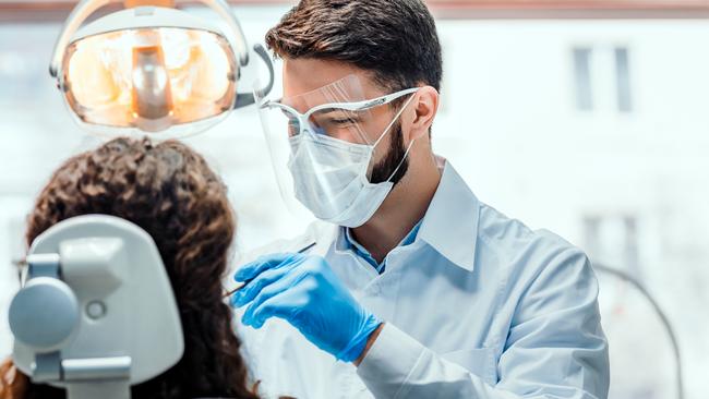 A dentist working on a patient.