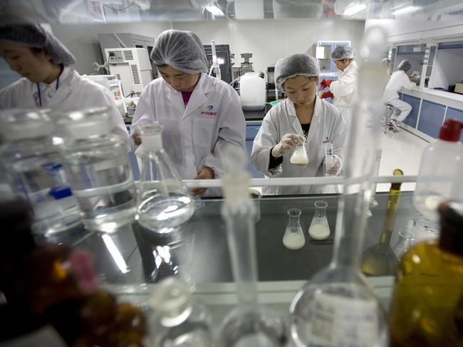 Chinese workers check for industrial chemical melamine in milk products in a lab after its contaminated milk powder scandal.