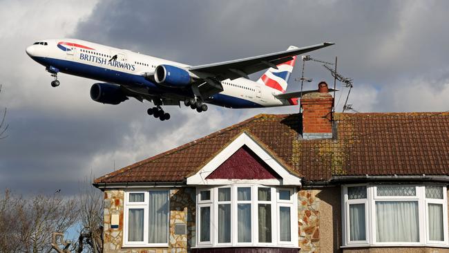 A British Airways Boeing 777-236 aircraft flies over houses as it prepares to land at London Heathrow Airport in west London over the weekend. Picture: AFP