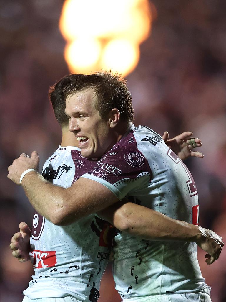 Jake Trbojevic and Luke Brooks celebrate beating Melbourne at 4 Pines Park. Picture: Cameron Spencer/Getty Images