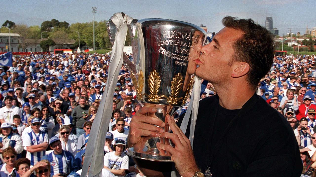 Wayne Carey kissing the 1999 AFL Premiership Cup in front of a crowd of North Melbourne supporters. Picture: Mark Smith.