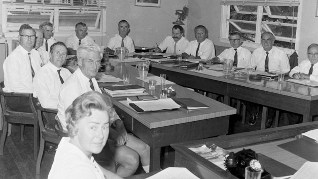 Councillors of the Albert Shire Council in the council offices, Scarborough Street, Southport, Queensland, April 1972. Left to right around table: Unidentified secretary, Cr John Rudd, Cr Merv Craig, Cr Allan McKavanagh, Cr Bill Birmingham, Cr Cliff Bird, Cr Charles Holm, Cr Patrick Fallon, Cr John Black, Cr Jack Davis, Cr Eddie Berndt, Cr Alex Fisher, Cr Billy Wolf. (From the City of Gold Coast picture archive)