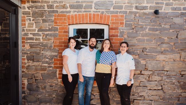 El Estanco’s Julian Velasquez and Abby Osborne stand with staff. Picture: Meghan Coles