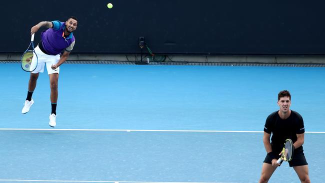 Nick Kyrgios serves in his men's doubles second-round match with partner Thanasi Kokkinakis of Australia against Lloyd Harris of South Africa and Julian Knowle of Austria during day six of the 2021 Australian Open at Melbourne Park on Saturday. Picture: Mark Metcalfe/Getty Images