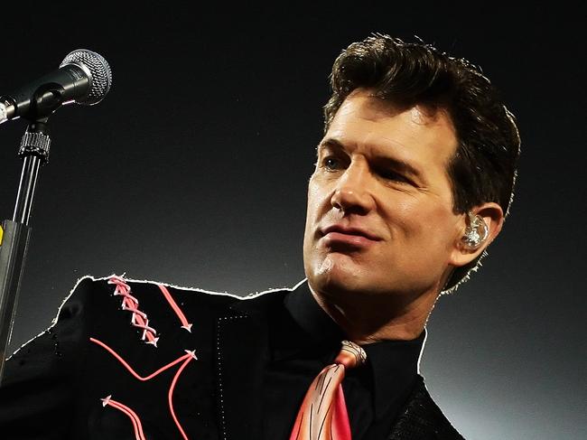 MELBOURNE, AUSTRALIA - MARCH 13: Chris Isaak performs at the half time break of the round one NRL match between the Melbourne Storm and the St George Illawarra Dragons at Olympic Park on March 13, 2009 in Melbourne, Australia. (Photo by Mark Dadswell/Getty Images)