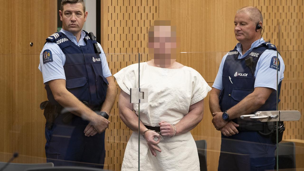 Tarrant in court flashing his right hand in an upside-down ‘OK’ signal, a symbol used by white power groups. Picture: Mark Mitchell/ Getty