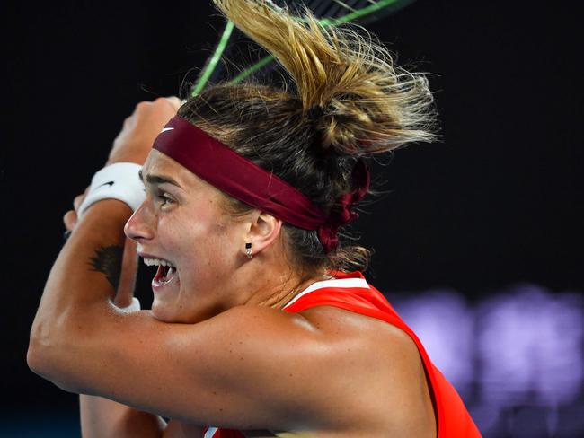 Belarus' Aryna Sabalenka hits a return against Australia's Storm Sanders during their women's singles match on day two of the Australian Open tennis tournament in Melbourne on January 18, 2022. (Photo by Paul Crock / AFP) / -- IMAGE RESTRICTED TO EDITORIAL USE - STRICTLY NO COMMERCIAL USE --