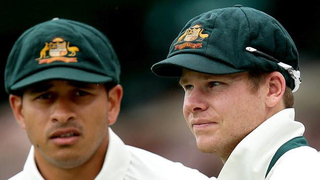 Test players Usman Khawaja (left) and Steve Smith wearing the men’s baggy green which features a red ribbon under the coat of arms