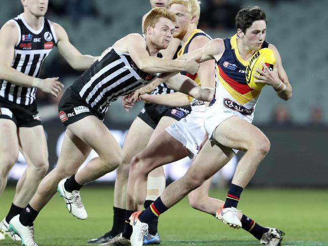 Crows SANFL captain Matthew Wright is enjoying being back in Adelaide’s colours and playing alongside the team’s developing players, including Chayce Jones. Jones is photographed shaking off a tackle in the Crows 30-point loss to Port Adelaide in the SANFL qualifying final on August 31 at Adelaide Oval. Picture: SARAH REED