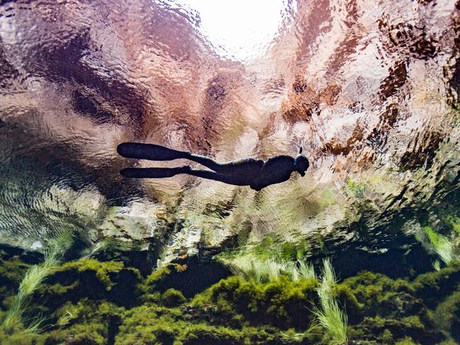 SUNDAY ESCAPE. AUSTRALIA DIVE WISHLIST. A snorkeller explores Kilsby Sinkhole on South Australia Limestone Coast. Picture: Jessie Cripps / SATC