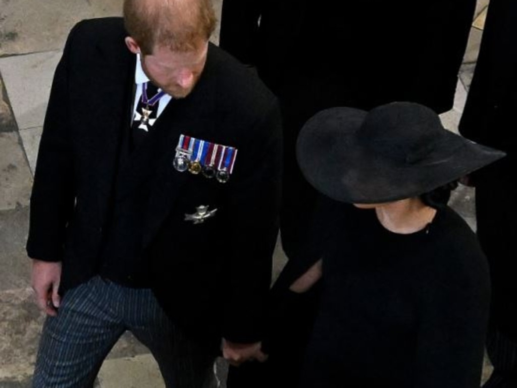 Prince Harry and Meghan Markle hold hands as they left Queen Elizabeth's funeral. Picture: Gareth Cattermole/Getty Images