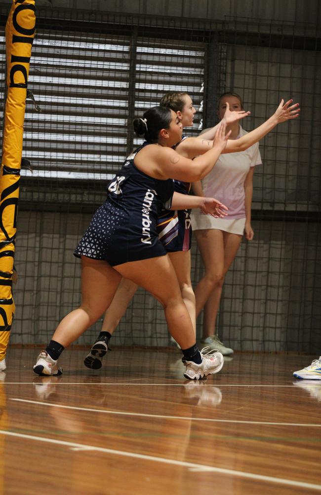 Netball action at QISSN 2024. Canterbury College v Good Shepherd Lutheran College
