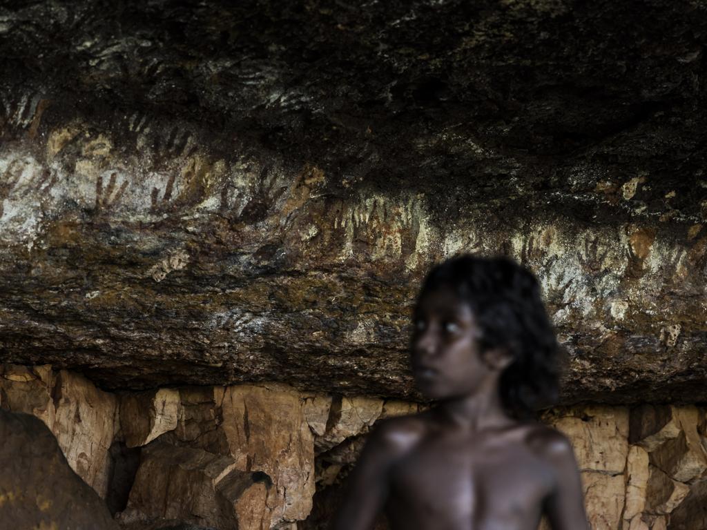 Local boy Lincoln Raymond looks at markings at indigenous sacred men's site near Wudikapildyerr, seen by guidance of local man Kenny Ahfat. Picture: Dylan Robinson