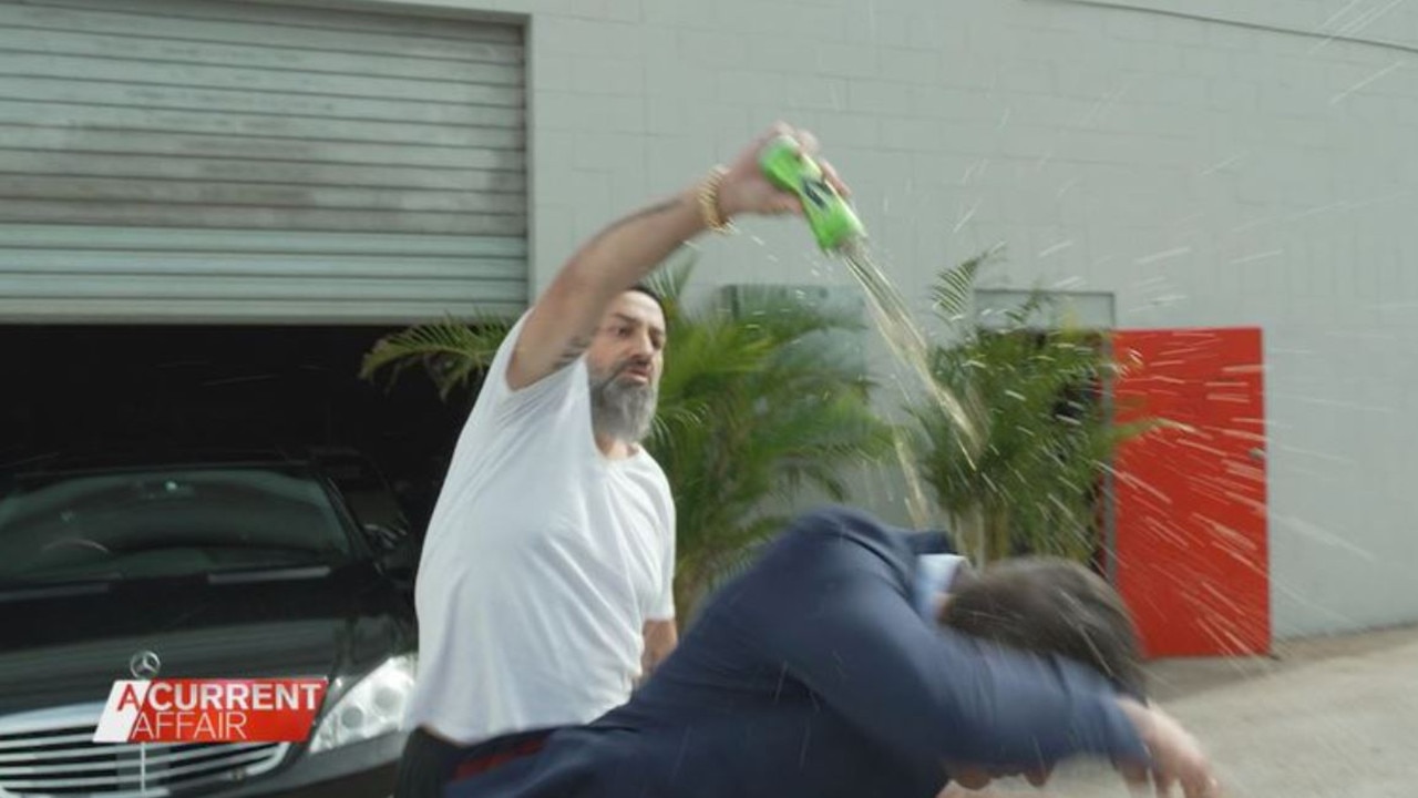 The used car salesman poured a drink on the unsuspecting journalist.