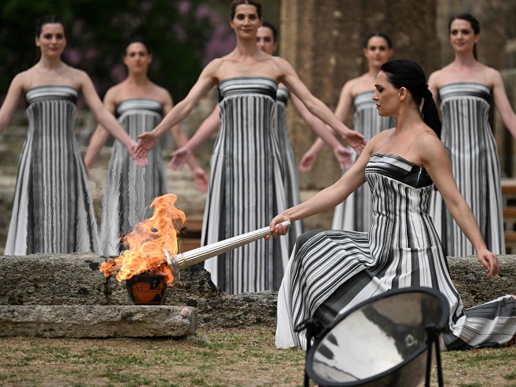 Greek actress Mary Mina, playing the role of the High Priestess, lights the torch for the Paris 2024 Olympics Games. The April 16 flame lighting ceremony in Greece was held at the ancient temple of Hera on the Olympia archeological site, birthplace of the Ancient Olympics. Picture: Aris Messinis/AFP