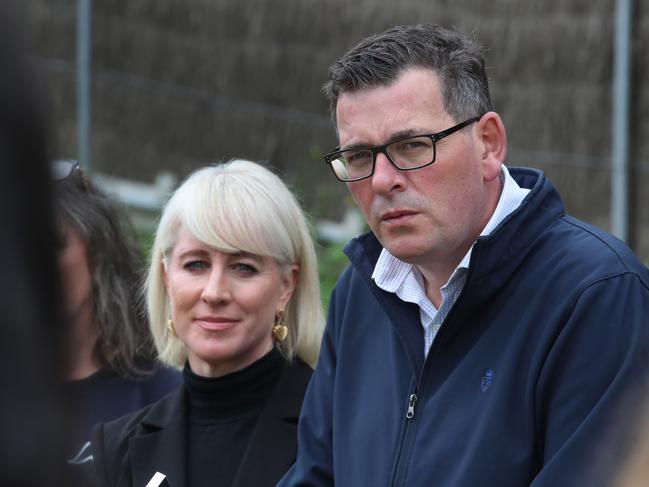 Cath and Dan Andrews jump off the campaign bus at a dog park. Picture: David Crosling