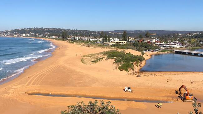 Northern Beaches Council started work on Friday morning to create a channel from Narrabeen Lagoon to the ocean. Picture: Jim O'Rourke