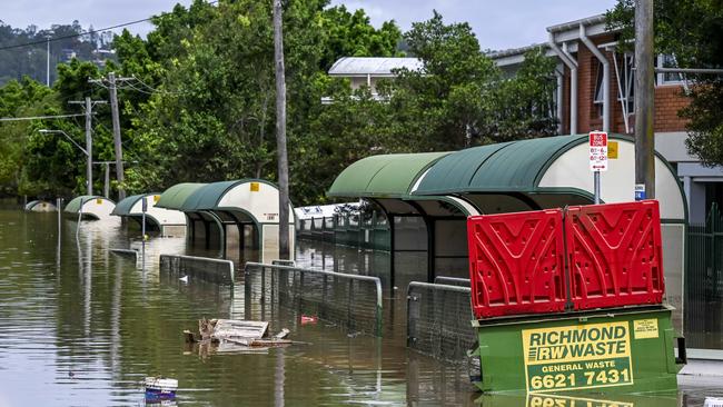 Mirrored reflections on the still flood waters with loads of rubbish surrounding Lismore suburbs. Picture: Darren Leigh Roberts