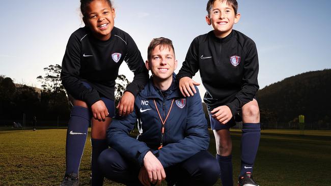 South Hobart FC Academy director, Ned Clarke alongside junior soccer players Talitha Otto, 10 and Finlay Soldatos, 8. Picture: Zak Simmonds