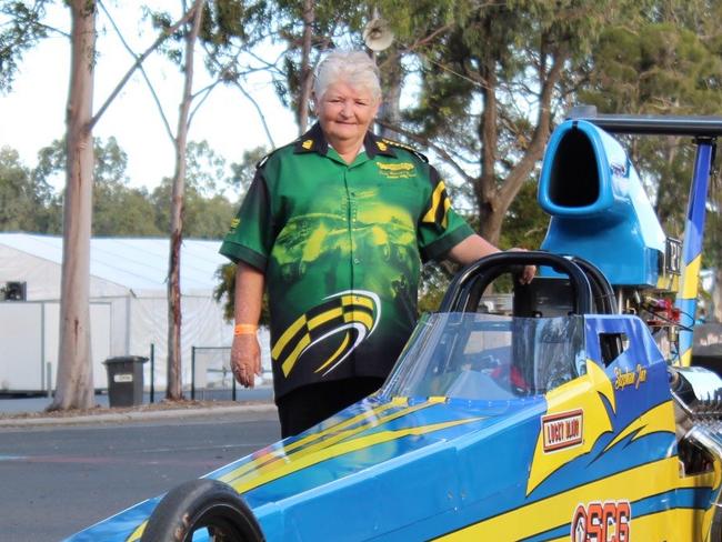 Long-serving Winternationals official Margaret Kreis with the modified car of Stephan Gouws racing at Willowbank Raceway this weekend.